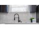 Modern kitchen sink with black faucet and white quartz countertop at 4401 Shore Acres Ne Blvd, St Petersburg, FL 33703
