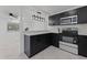 Modern kitchen with dark cabinets, stainless steel appliances, and breakfast bar at 4401 Shore Acres Ne Blvd, St Petersburg, FL 33703
