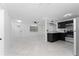 Modern kitchen with dark cabinets and stainless steel appliances at 4401 Shore Acres Ne Blvd, St Petersburg, FL 33703