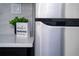 Kitchen detail showing white quartz countertop and stainless steel refrigerator at 4401 Shore Acres Ne Blvd, St Petersburg, FL 33703
