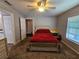 Bedroom with a red comforter on the bed, a ceiling fan and a dresser at 2022 Peaceful Palm St, Ruskin, FL 33570