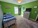 Well-lit bedroom, green walls, and ample closet space at 2022 Peaceful Palm St, Ruskin, FL 33570