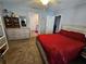 Main bedroom with red bedding and large dresser at 2022 Peaceful Palm St, Ruskin, FL 33570