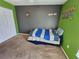 Spacious bedroom with green walls and a comfortable bed at 2022 Peaceful Palm St, Ruskin, FL 33570