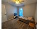 Bedroom featuring carpet flooring, ceiling fan, and natural light from the window at 2022 Peaceful Palm St, Ruskin, FL 33570