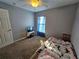 Bright bedroom featuring a window and neutral wall colors at 2022 Peaceful Palm St, Ruskin, FL 33570