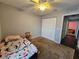 Bedroom showing closet and carpet flooring at 2022 Peaceful Palm St, Ruskin, FL 33570