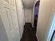 Dark wood floor hallway with doors to bedrooms and closets at 2022 Peaceful Palm St, Ruskin, FL 33570