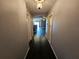 Long hallway with dark hardwood floors and archways at 2022 Peaceful Palm St, Ruskin, FL 33570