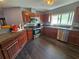 Well-lit kitchen featuring dark wood cabinetry, stainless steel appliances, and a stylish backsplash at 2022 Peaceful Palm St, Ruskin, FL 33570