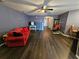 Living room with dark hardwood floors and red couch at 2022 Peaceful Palm St, Ruskin, FL 33570