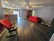 Living room with dark hardwood floors and red couch at 2022 Peaceful Palm St, Ruskin, FL 33570