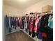 Neatly organized walk-in closet with shelves and hanging rods for efficient storage of clothes at 2022 Peaceful Palm St, Ruskin, FL 33570