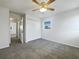 Bedroom with ceiling fan, carpet, and ample closet space at 4000 Barbary Ln, North Port, FL 34287