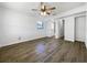 Bright bedroom with ceiling fan and wood-look tile floors at 4000 Barbary Ln, North Port, FL 34287