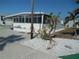 Mobile home with unique yard art and landscaping at 10315 Cortez W Rd # 26Bv, Bradenton, FL 34210