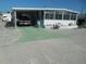 Mobile home with carport and landscaped yard at 10315 Cortez W Rd # 26Bv, Bradenton, FL 34210