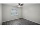 Bright bedroom with ceiling fan and gray wood-look tile floors at 13910 Fullerton Dr, Tampa, FL 33625