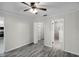 Bedroom with hardwood floors, access to a walk-in closet, and an ensuite bathroom at 13910 Fullerton Dr, Tampa, FL 33625