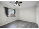 Well-lit bedroom with ceiling fan and gray tile flooring at 13910 Fullerton Dr, Tampa, FL 33625