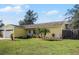 Bright yellow house with a lush green lawn and palm trees at 13910 Fullerton Dr, Tampa, FL 33625