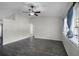 Spacious living room featuring gray tile floors and a ceiling fan at 13910 Fullerton Dr, Tampa, FL 33625