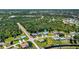 Aerial view showing home's location in a residential neighborhood with lush landscaping at 143 Long Meadow Ln, Rotonda West, FL 33947