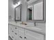 Bathroom with a double vanity and large mirrors at 143 Long Meadow Ln, Rotonda West, FL 33947