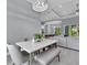 Dining area with marble top table, gray chairs and bench, open to the living room at 143 Long Meadow Ln, Rotonda West, FL 33947