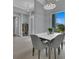 Modern dining area with a white table and gray chairs, near entryway at 143 Long Meadow Ln, Rotonda West, FL 33947