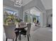 Bright dining room with wooden table and gray chairs, opening to a screened patio at 143 Long Meadow Ln, Rotonda West, FL 33947