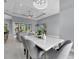 Open concept dining area with a marble top table and gray chairs at 143 Long Meadow Ln, Rotonda West, FL 33947