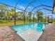 Relaxing screened-in pool with a water feature at 143 Long Meadow Ln, Rotonda West, FL 33947