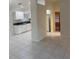 A view of the bright kitchen featuring white cabinets and tile flooring at 4666 Laramie Cir, North Port, FL 34286