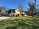 Two-story house with a screened porch, attached garage, and spacious yard at 7027 Hawkins Rd, Sarasota, FL 34241