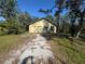 Detached garage with gravel driveway and surrounding trees at 7027 Hawkins Rd, Sarasota, FL 34241