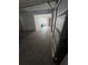 Attached garage with open door and concrete floor at 7027 Hawkins Rd, Sarasota, FL 34241