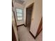 Bright hallway with window, carpet, and closet at 7027 Hawkins Rd, Sarasota, FL 34241
