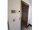Hallway with thermostat, security panel, and closet at 7027 Hawkins Rd, Sarasota, FL 34241