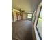Bright sunroom with wood paneling, carpet, and view of backyard at 7027 Hawkins Rd, Sarasota, FL 34241