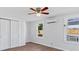 Spacious bedroom with hardwood floors, ceiling fan and double closet at 8025 Roy Dr, Punta Gorda, FL 33982