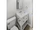 Small bathroom with white vanity and gold accents at 9640 Mark Twain Ln, Port Richey, FL 34668