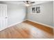 Simple bedroom with light wood floors and a window at 9640 Mark Twain Ln, Port Richey, FL 34668