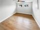 Spacious bedroom with wood-look flooring and two windows at 9640 Mark Twain Ln, Port Richey, FL 34668
