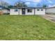 Newly renovated house with a large front yard and driveway at 9640 Mark Twain Ln, Port Richey, FL 34668
