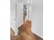 Clean hallway with light walls and wood-look flooring at 9640 Mark Twain Ln, Port Richey, FL 34668