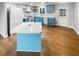 Updated kitchen featuring light blue cabinetry and an island at 9640 Mark Twain Ln, Port Richey, FL 34668