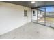 Screened porch with concrete floor and access to backyard at 9640 Mark Twain Ln, Port Richey, FL 34668