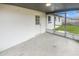 Screened porch with concrete floor and access to backyard at 9640 Mark Twain Ln, Port Richey, FL 34668