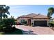 Single-story home with driveway and landscaping in a residential area at 4777 Royal Dornoch Cir, Bradenton, FL 34211